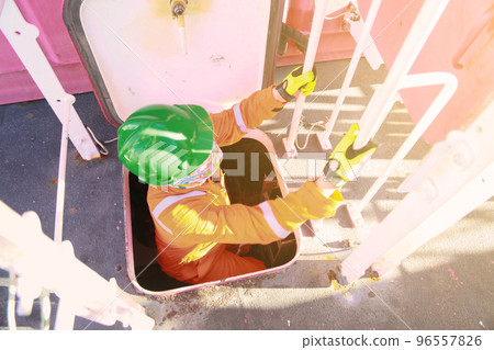 Offshore oil and gas industry and operated by technician petroleum. Worker walking to oil and gas plant for work as routine plan. Maintenance and Operation work scope in oil and gas plant. Offshore oil and gas industry and operated by technician petroleum. Worker walking to oil and gas plant for work as routine plan. Maintenance and Operation work scope in oil and gas plant. 96557826