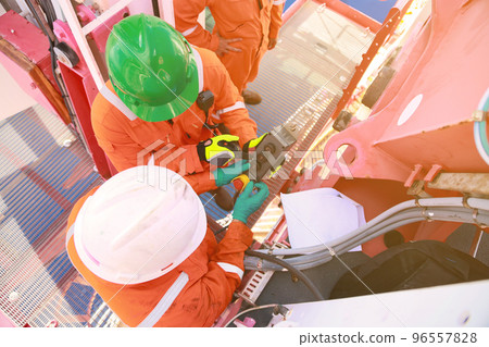 Offshore oil and gas industry and operated by technician petroleum. Worker walking to oil and gas plant for work as routine plan. Maintenance and Operation work scope in oil and gas plant. 96557828
