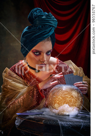Mysticism. Portrait of mysterious soothsayer and molfarka guesses and predicts fate. Retro circus, mysticism and witchcraft. Concept of art, creativity and inspiration 96558767