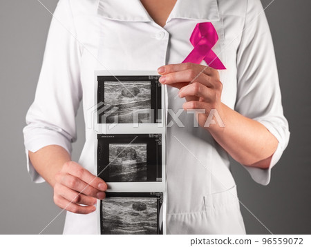 Breast ultrasound result, scan in doctor hand. Checkup for October awareness day Breast ultrasound result, scan in doctor hand. Checkup for October awareness day 96559072