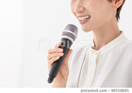 Woman holding a microphone White background Woman holding a microphone White background 96559685