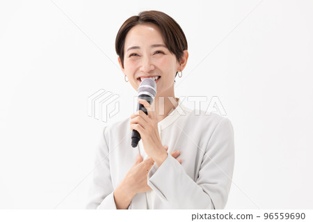 Woman holding a microphone White background Woman holding a microphone White background 96559690