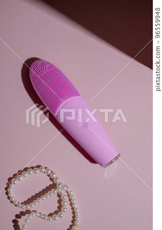 Pink silicone brush, face washing device. Beauty device. Deep cleanser and massager on pink background Pink silicone brush, face washing device. Beauty device. Deep cleanser and massager on pink background 96559948