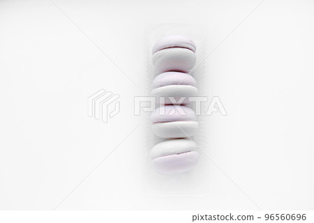 White and pink marshmallows on a white background. Marshmallows in plastic packaging. A sweet snack. White and pink marshmallows on a white background. Marshmallows in plastic packaging. A sweet snack. 96560696