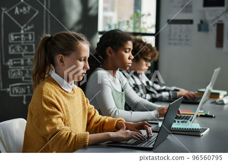 Group of children concentrating on their online work on computers during IT technology lesson 96560795