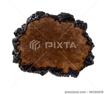 Black truffle slice in oil macro cutout. One truffle carpaccio slice isolated on a white background. 96560856
