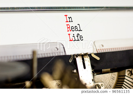 IRL in real life symbol. Concept words IRL in real life typed on the old retro typewriter on a beautiful white background. Business and IRL in real life concept. Copy space. 96561135