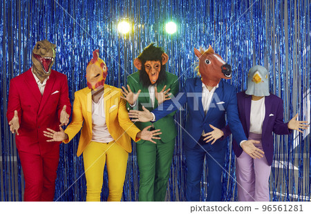 People in funny masks of heads of different animals are dancing at disco party on shiny background. 96561281