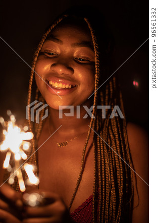The joy of an African woman during the burning of cold fires. New Year. 96561332