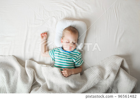 Toddler boy sleeping close-up on bed. Health care concept Toddler boy sleeping close-up on bed. Health care concept 96561482