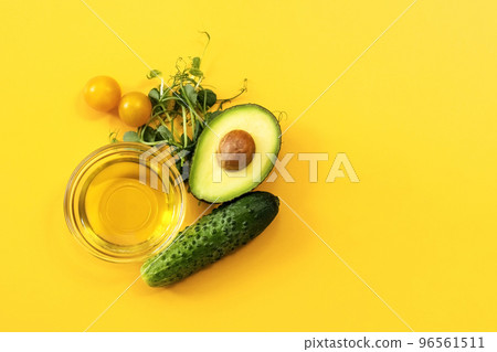 Ingredients of healthy food. Micro green pea sprouts, olive oil, cucumber, tomato, avocado. Ketogenic low carbs diet concept. 96561511