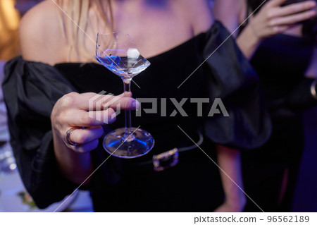 broken glass of champagne in hand Clinking glasses with alcohol and toasting, party. broken glass of champagne in hand Clinking glasses with alcohol and toasting, party. 96562189