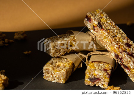 Homemade Granola energy bar. Variety of homemade protein granola breakfast bars with nuts, raisins dried cherries and chocolate. Healthy nutrition eating Gluten free cereal dieting snack super food Homemade Granola energy bar. Variety of homemade protein granola breakfast bars with nuts, raisins dried cherries and chocolate. Healthy nutrition eating Gluten free cereal dieting snack super food 96562835