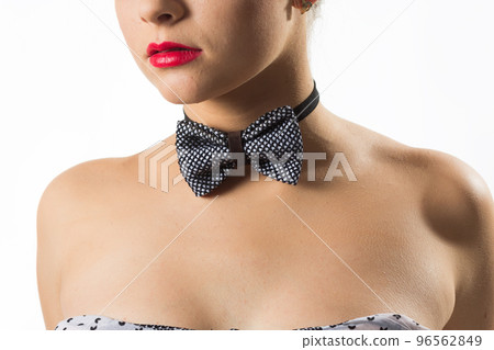 Cute cute girl smiling on a blank wall background. Young woman in hand holds glasses. Place for advertising, copy space. 96562849