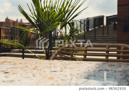 Defocused Empty abstract blurred restaurant background. Blurry cafe terrace on day time with palm trees or coffee shop chairs Defocused Empty abstract blurred restaurant background. Blurry cafe terrace on day time with palm trees or coffee shop chairs 96562930