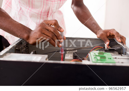 a computer expert repairs a computer a computer expert repairs a computer 96562957