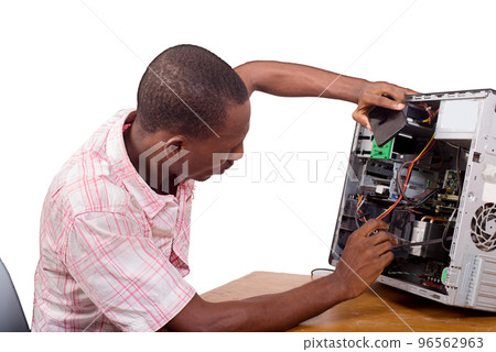 young technician repairing a computer young technician repairing a computer 96562963