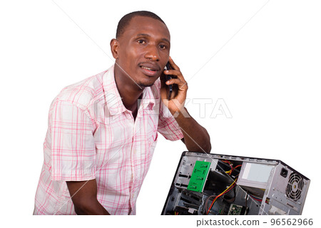 Young technician leaning against a broken computer Young technician leaning against a broken computer 96562966