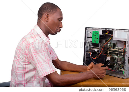 young technician sitting and repairing a desktop computer in fro young technician sitting and repairing a desktop computer in fro 96562968