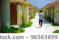 A man walking in a resort hotel 96563899