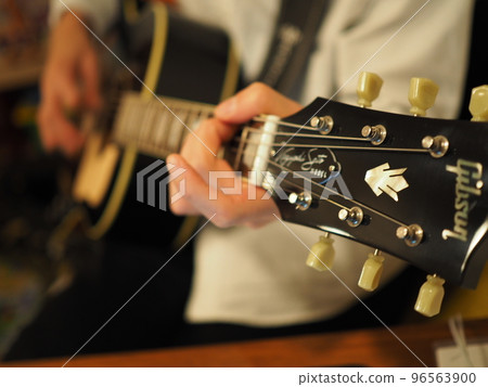 A man playing an acoustic guitar A man playing an acoustic guitar 96563900