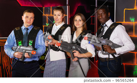 males and females in business suits posing at laser tag room 96565264