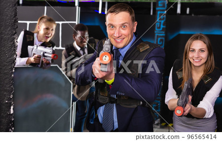 Man holding laser gun and playing laser tag Man holding laser gun and playing laser tag 96565414