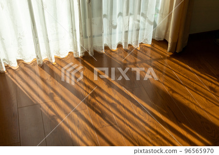 Sunlight shining through the window into the wooden floor room Sunlight shining through the window into the wooden floor room 96565970