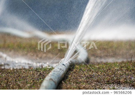 Water leaking from hole in a hose. Water leaking from hole in a hose. 96566206