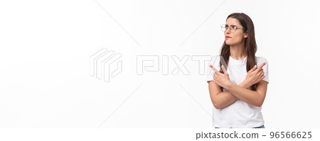 Waist-up portrait of troubled, thoughtful and indecisive young 20s woman in glasses, frowning skeptical and hesitant, cross hands pointing left and right, two variants both good, thinking what choose 96566625