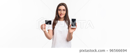 Portrait of excited and tempting young woman likes shopping, cant wait to use her new credit card in online store, showing mobile phone screen, brag with her bank account, bite lip thrilled Portrait of excited and tempting young woman likes shopping, cant wait to use her new credit card in online store, showing mobile phone screen, brag with her bank account, bite lip thrilled 96566694