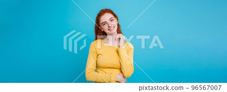 Portrait of happy ginger red hair girl with freckles smiling looking at camera. Pastel blue background. Copy Space Portrait of happy ginger red hair girl with freckles smiling looking at camera. Pastel blue background. Copy Space 96567007