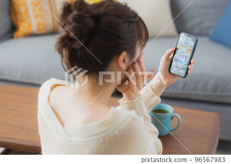 Living room smartphone woman Living room smartphone woman 96567983