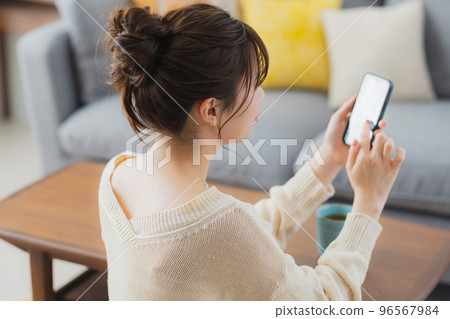 Living room smartphone woman 96567984