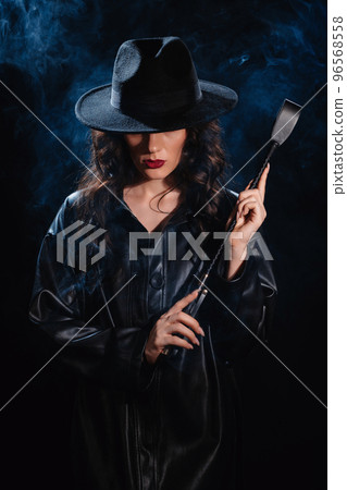 Sexy female dominant mistress with a whip flogger for BDSM sex 96568558