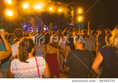 Crowd raising their hands and enjoying great festival party or concert. 96569745