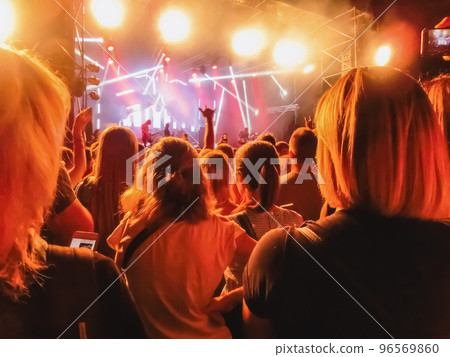 Crowd raising their hands and enjoying great festival party or concert. Crowd raising their hands and enjoying great festival party or concert. 96569860