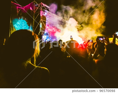 Crowd raising their hands and enjoying great festival party or concert. Crowd raising their hands and enjoying great festival party or concert. 96570098