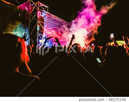 Crowd raising their hands and enjoying great festival party or concert. Crowd raising their hands and enjoying great festival party or concert. 96570100