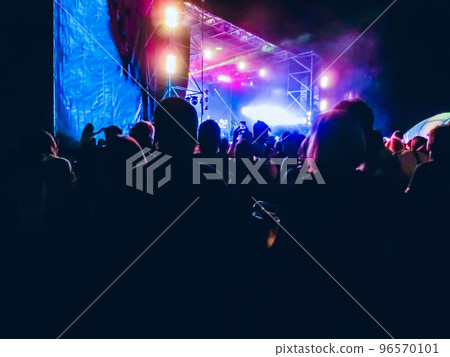 Crowd raising their hands and enjoying great festival party or concert. Crowd raising their hands and enjoying great festival party or concert. 96570101