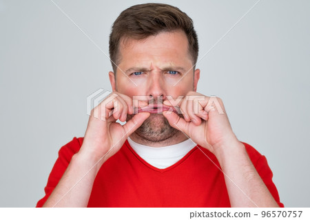 man closes a mouth hands being afraid to smile or speak. Teeth problem man closes a mouth hands being afraid to smile or speak. Teeth problem 96570757