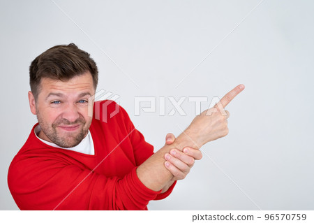 Serious man pointing finger up showing logo promo aside, pay attention here 96570759