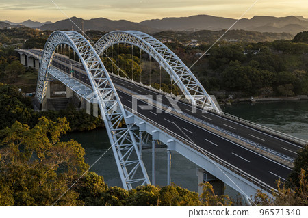 Shinsaikai Bridge illuminated by the morning sun from the observatory of Saikai no Oka Park Shinsaikai Bridge illuminated by the morning sun from the observatory of Saikai no Oka Park 96571340