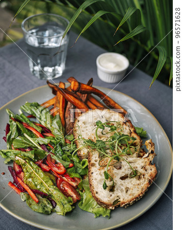 Sweet potato fries with rosmary and fresh salad 96571628