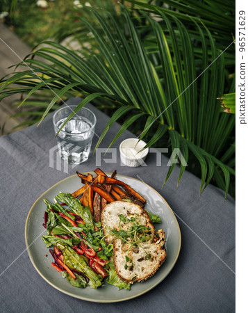 Sweet potato fries with rosmary and fresh salad 96571629