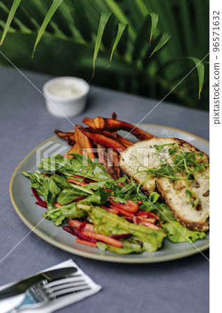 Sweet potato fries with rosmary and fresh salad 96571632