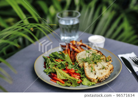 Sweet potato fries with rosmary and fresh salad 96571634