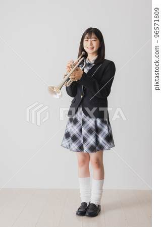 A high school girl with a trumpet A high school girl with a trumpet 96571809