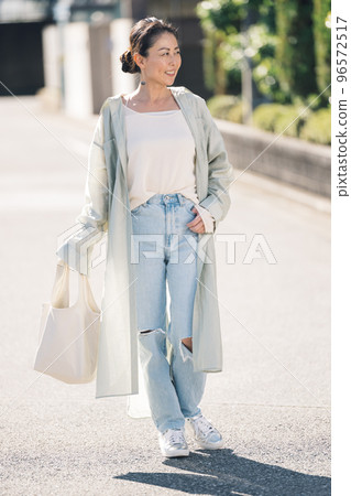 Middle-aged woman walking in the city Middle-aged woman walking in the city 96572517
