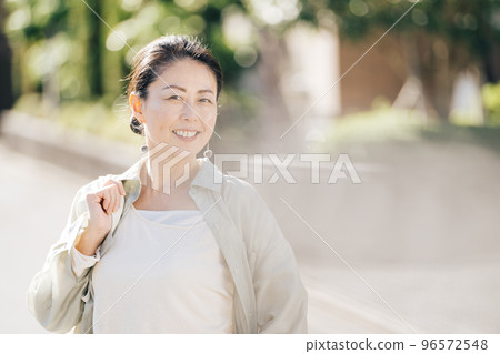 Middle-aged woman walking in the city Middle-aged woman walking in the city 96572548